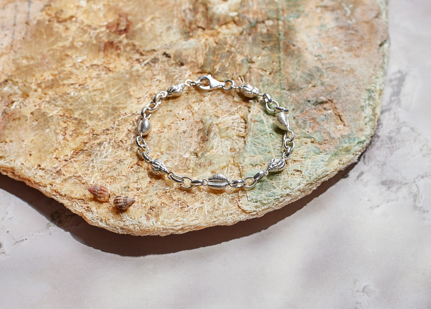 Langland bracelet. Langland Bay, Gower. Gower jewellery. Cowrie shell jewellery. Cowrie shell bracelet. Welsh jewellery. Shell bracelet. Silver shell bracelet. Welsh shell jewellery. Silver shell jewellery. Gold shell jewellery. Those Happy Places. Serena Ansell Jewellery.
