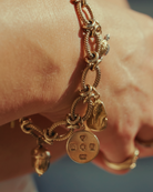 Charm. Gold disc charm. Silver disc charm. 