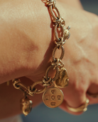 Gold charm bracelet. Gold disc charm. 
