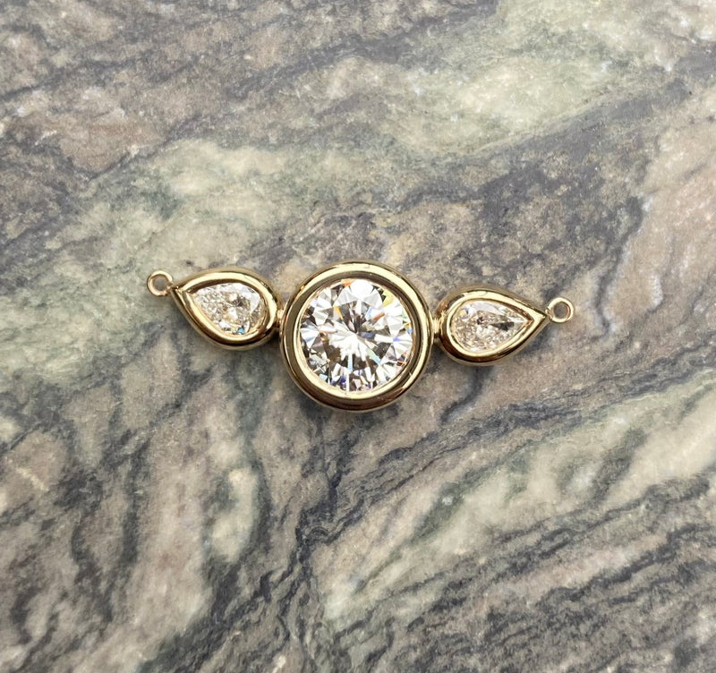 A three-stone engagement ring redesigned into a pendant